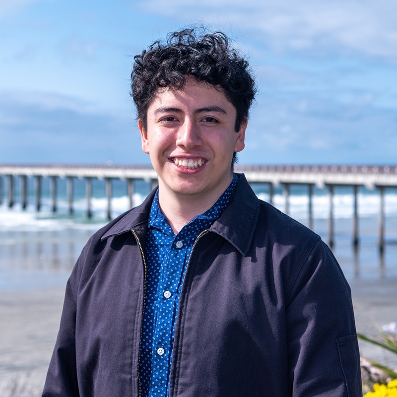 Professional portrait of Jesus Azpitarte smiling on the La Jolla Shores Boardwalk.